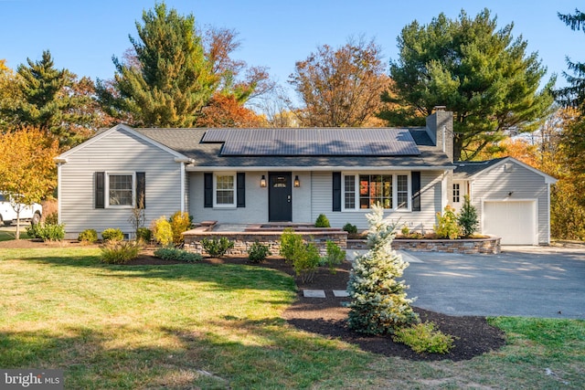 single story home featuring a front lawn and a garage