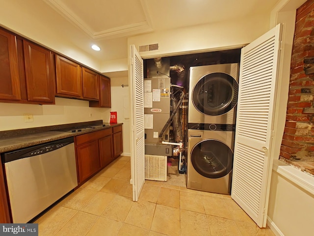 interior space with ornamental molding and stacked washer and clothes dryer