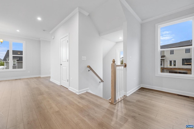 interior space with light hardwood / wood-style flooring and crown molding