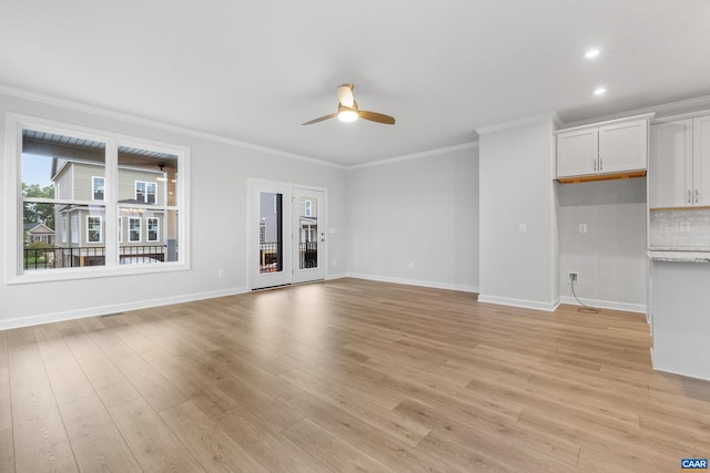 unfurnished living room featuring ceiling fan, light wood-type flooring, and crown molding