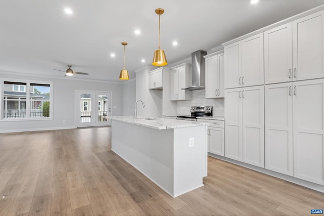 kitchen featuring wall chimney exhaust hood, white cabinets, ceiling fan, and stainless steel electric stove