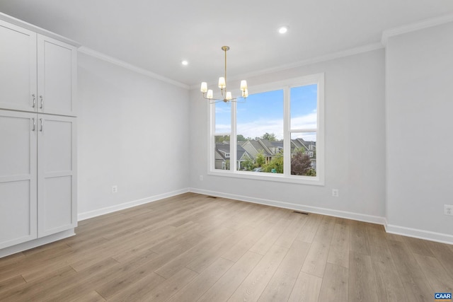 unfurnished dining area featuring a notable chandelier, light wood-type flooring, and crown molding