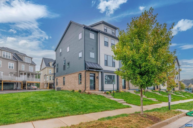 townhome / multi-family property with central AC unit and a front yard