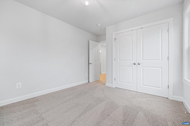 unfurnished bedroom with carpet floors and a closet