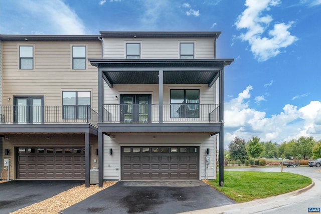 view of front of home with a balcony and a garage