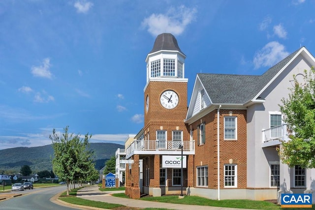 exterior space featuring a balcony and a mountain view