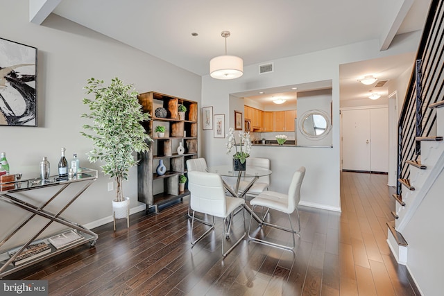 dining room with dark wood-type flooring