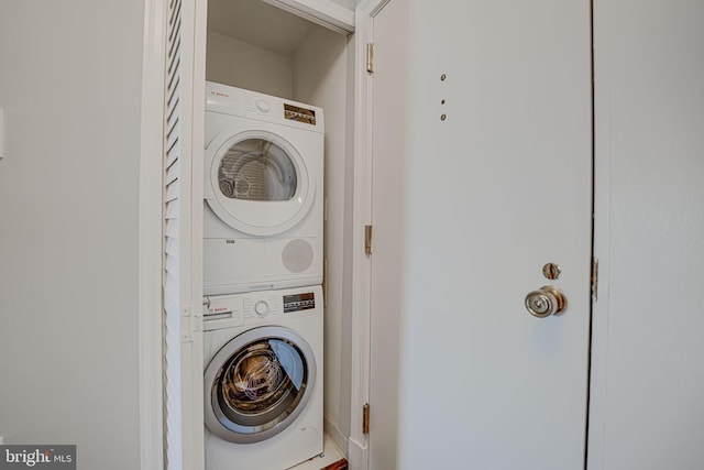 laundry area with stacked washing maching and dryer