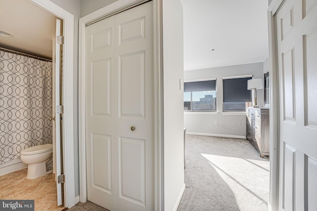 bathroom featuring toilet and a shower with shower curtain