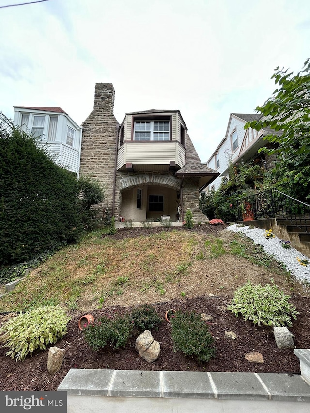 back of house featuring a balcony