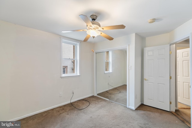 unfurnished bedroom with ceiling fan, light colored carpet, and a closet