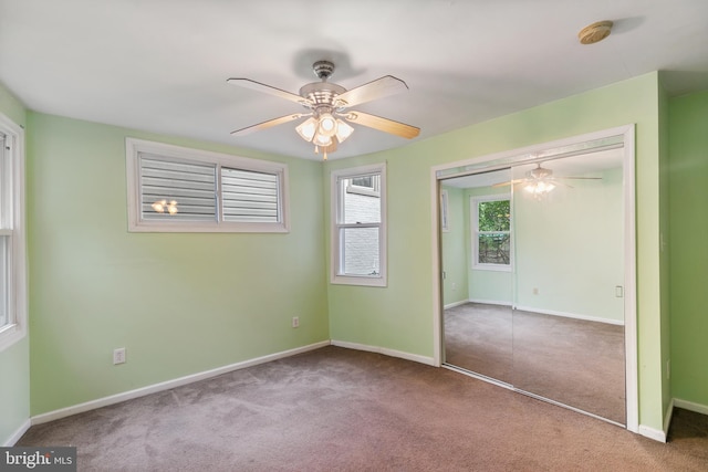 unfurnished bedroom with ceiling fan, a closet, and carpet flooring