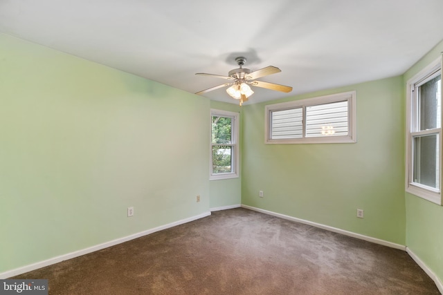 unfurnished room with ceiling fan and carpet flooring