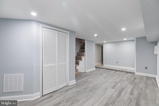 basement with light hardwood / wood-style floors