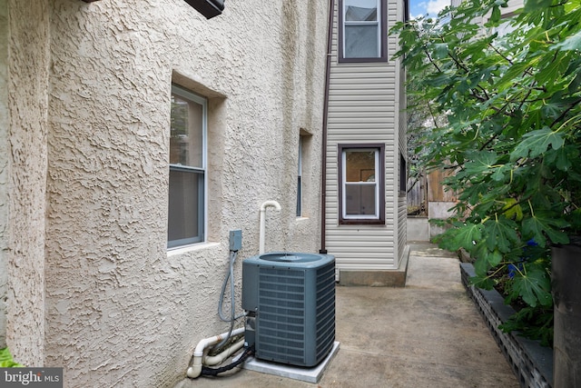 exterior space with central AC unit and a patio area