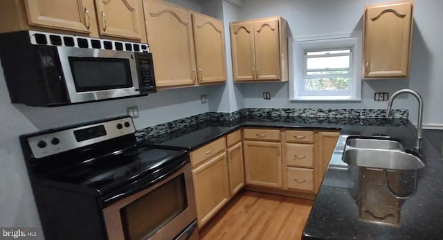 kitchen featuring light brown cabinets, sink, and stainless steel appliances