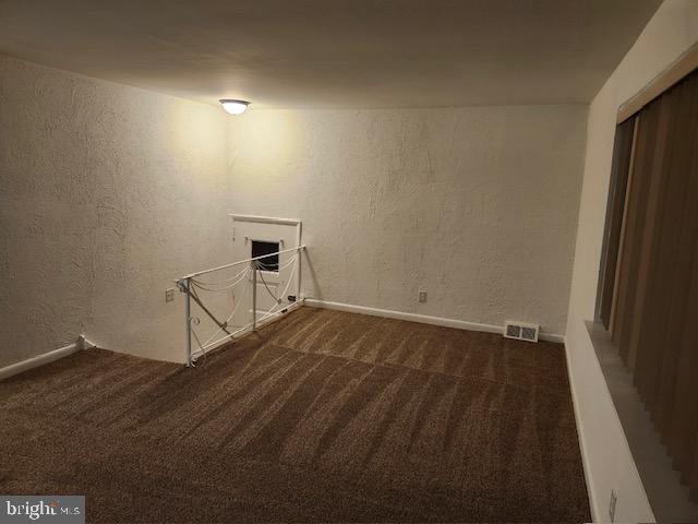 interior space with dark colored carpet