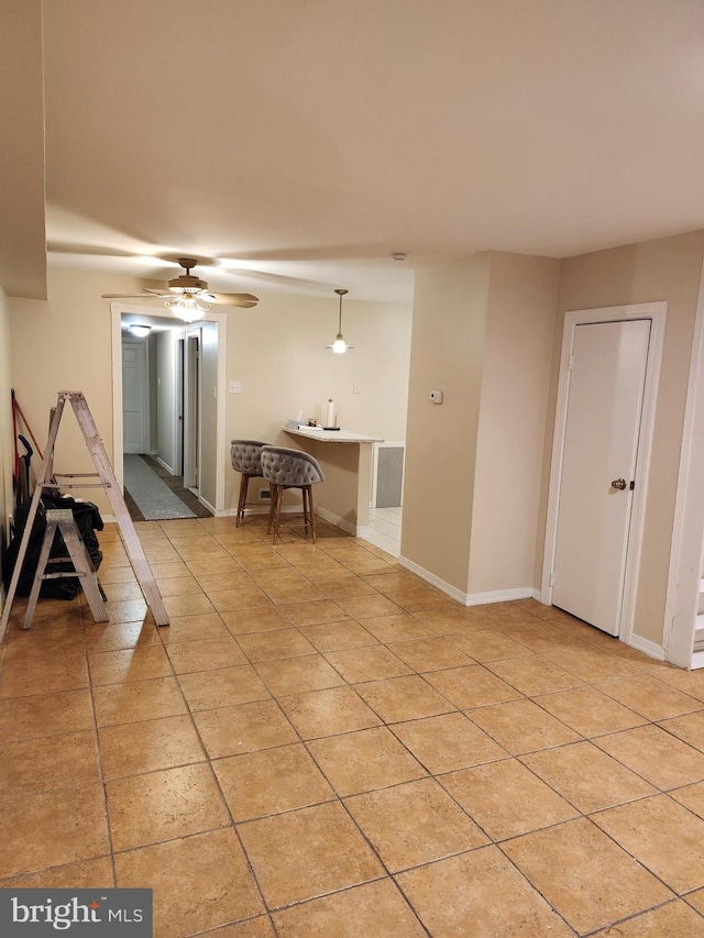 interior space with ceiling fan