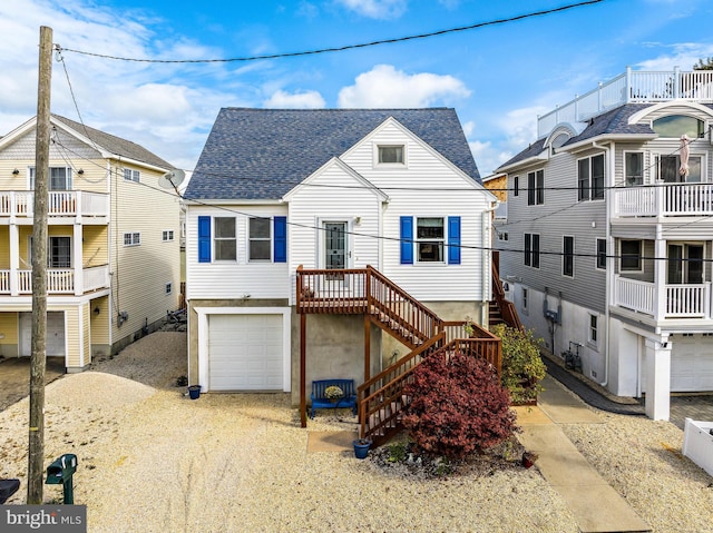 view of front of property with a balcony and a garage