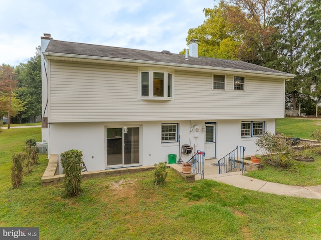 rear view of house with a yard