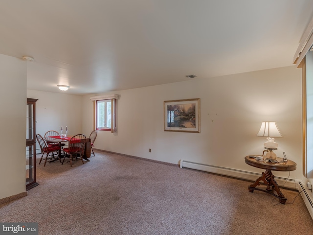 dining area featuring carpet floors and a baseboard heating unit