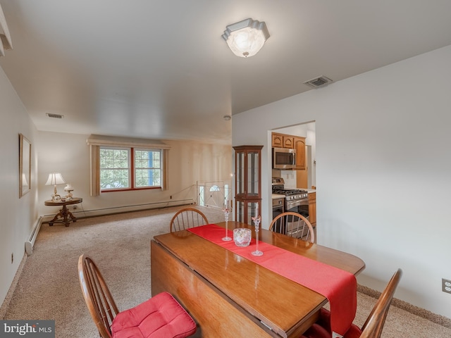 carpeted dining room with baseboard heating