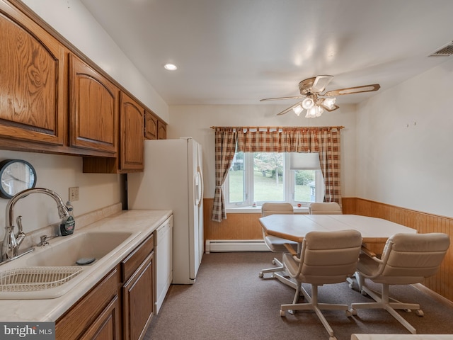 kitchen with baseboard heating, sink, white dishwasher, and carpet floors