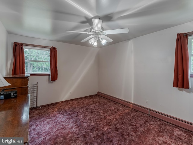 empty room with a baseboard heating unit, ceiling fan, and carpet flooring