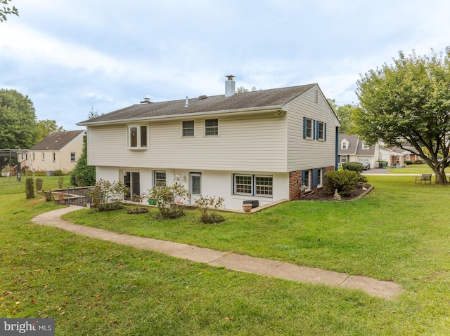 rear view of property featuring a yard