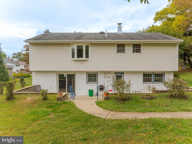 back of property featuring a patio and a yard