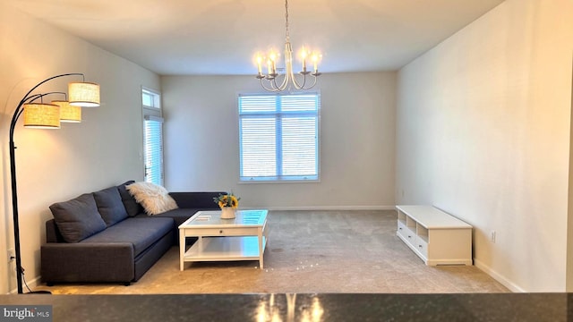 carpeted living room with a chandelier