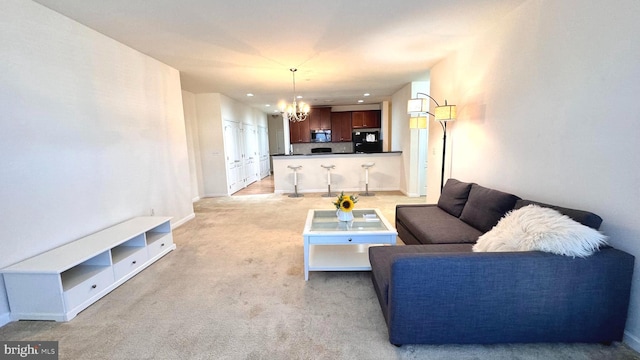 carpeted living room with a chandelier