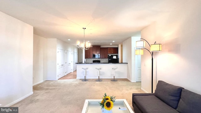 living room with a notable chandelier and light carpet