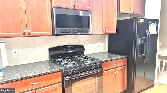 423 Carson Ter, Huntingdon Valley, PA 19006 - kitchen with black appliances, decorative backsplash, and dark stone counters