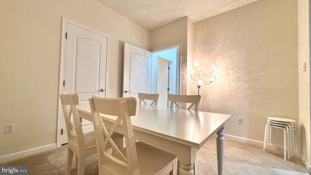 dining area featuring light colored carpet