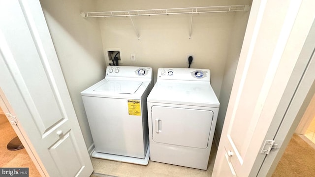 washroom with washer and dryer and light carpet