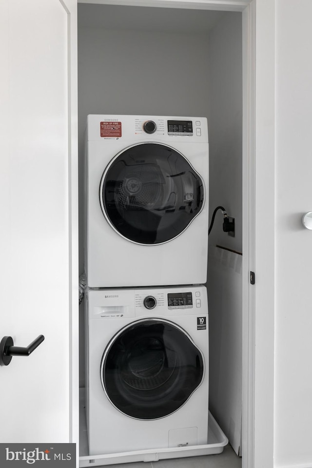 laundry room with stacked washer and dryer