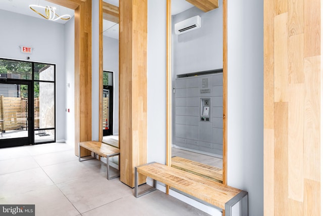 interior space featuring a towering ceiling and a wall unit AC