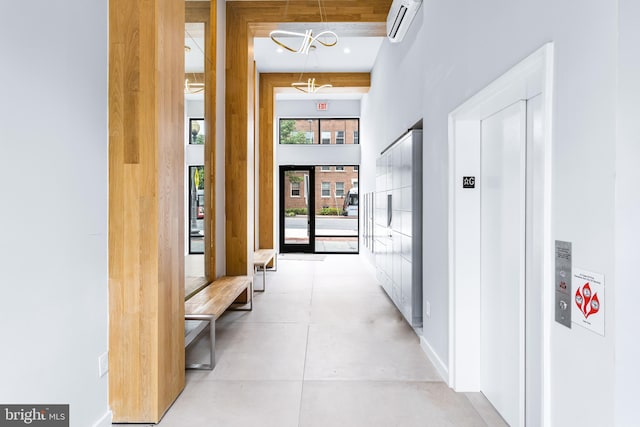 corridor with a high ceiling and a wall unit AC