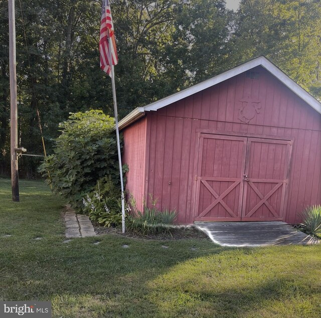 view of outdoor structure featuring a lawn