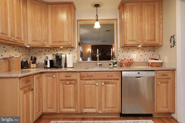 kitchen featuring light wood-type flooring, backsplash, sink, and stainless steel dishwasher