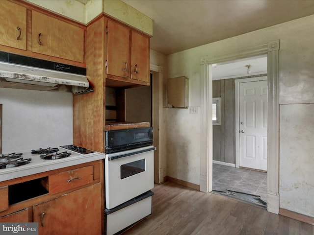 kitchen with hardwood / wood-style flooring and oven