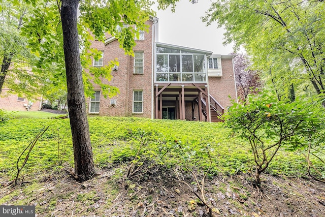 back of house featuring a sunroom