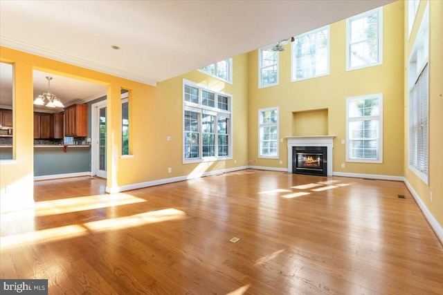 unfurnished living room featuring light wood-type flooring and a wealth of natural light