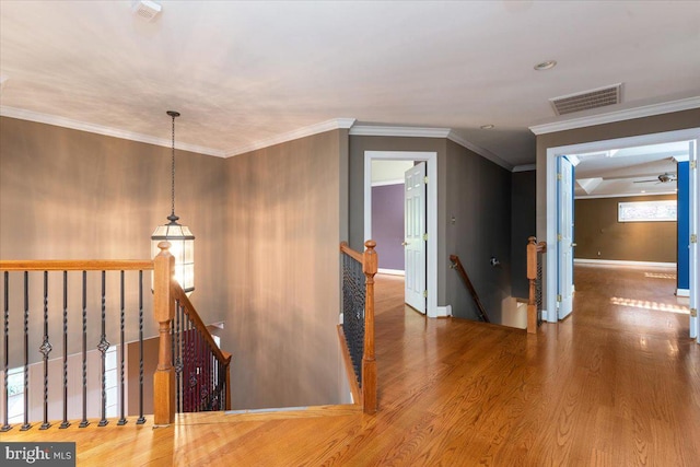 hall featuring ornamental molding and hardwood / wood-style flooring