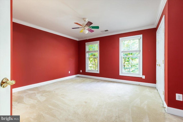 carpeted empty room with ceiling fan and crown molding