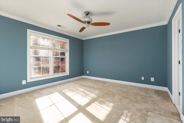 unfurnished room with light colored carpet, ceiling fan, and crown molding