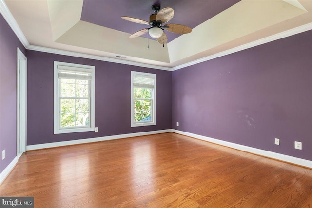 spare room featuring wood-type flooring, ceiling fan, and crown molding