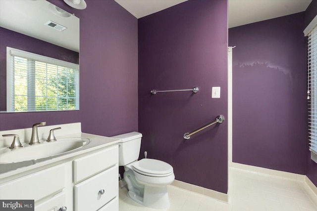 bathroom with tile patterned flooring, vanity, and toilet