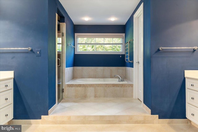 bathroom with tile patterned flooring, vanity, and shower with separate bathtub